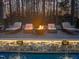 Relaxing poolside scene featuring comfortable lounge chairs, an inviting fire pit, and soothing water features at 1012 Casa Dega Way, Raleigh, NC 27613