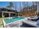 Beautiful backyard with a large pool, tanning deck, and comfortable lounge chairs at 1012 Casa Dega Way, Raleigh, NC 27613