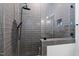 Modern tiled shower with glass door, a rain shower head, and built-in shelving for toiletries at 1012 Casa Dega Way, Raleigh, NC 27613