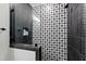 Shower featuring modern black and white patterned tile and glass door at 1012 Casa Dega Way, Raleigh, NC 27613