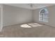 Bright bedroom featuring a large arched window, neutral walls, and plush carpeting at 103 Fieldstone Dr, Clayton, NC 27520