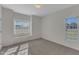 Bright bedroom featuring carpet flooring and two large windows at 103 Fieldstone Dr, Clayton, NC 27520