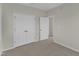 Carpeted bedroom featuring a closet with double doors and an open doorway at 103 Fieldstone Dr, Clayton, NC 27520