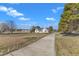 Exterior shot of a home with long driveway and large grassy lawn at 103 Fieldstone Dr, Clayton, NC 27520