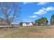 Wide angle shot of a single story home surrounded by a large grassy lawn at 103 Fieldstone Dr, Clayton, NC 27520