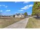 Exterior view of a home with a long driveway and spacious grassy lawn at 103 Fieldstone Dr, Clayton, NC 27520