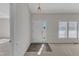 Bright foyer featuring a stylish light fixture, neutral walls, and wood-look flooring at the front door at 103 Fieldstone Dr, Clayton, NC 27520