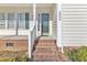 Close-up of a home's front entrance featuring brick steps and white trim at 103 Fieldstone Dr, Clayton, NC 27520