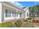 Exterior shot of a home's front entrance with a covered front porch and green shutters at 103 Fieldstone Dr, Clayton, NC 27520