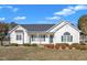 Charming single-story home featuring a covered front porch and well-manicured landscaping at 103 Fieldstone Dr, Clayton, NC 27520