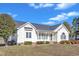 Exterior view of a single-story home with a covered front porch and landscaped garden at 103 Fieldstone Dr, Clayton, NC 27520