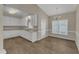 Kitchen with white cabinetry, modern appliances, and a spacious dining area filled with natural light at 103 Fieldstone Dr, Clayton, NC 27520