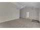 Spacious living room with neutral carpet, ceiling fan, and an open layout leading to the entryway at 103 Fieldstone Dr, Clayton, NC 27520