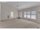 Open-concept living space with vaulted ceiling, a ceiling fan and large windows for lots of natural light at 103 Fieldstone Dr, Clayton, NC 27520