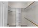 Walk-in closet featuring built-in shelving and rods for ample storage, plus neutral carpeting at 103 Fieldstone Dr, Clayton, NC 27520