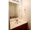 Clean bathroom featuring a single sink vanity and a large mirror for optimal lighting at 105 Cross Hill Ln, Holly Springs, NC 27540