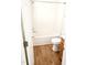 Bright bathroom with a tub and shower combination, toilet, and wood-look flooring at 105 Cross Hill Ln, Holly Springs, NC 27540