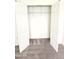 Walk-in closet featuring built-in shelving and ample storage space with neutral carpet at 105 Cross Hill Ln, Holly Springs, NC 27540