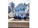 Charming two-story home with blue shutters and a well-maintained front yard with beautiful plants at 105 Cross Hill Ln, Holly Springs, NC 27540