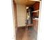 Small utility closet with plywood walls and water heater at 105 Cross Hill Ln, Holly Springs, NC 27540