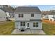 Backyard of a house featuring a patio with a fire pit and two white rocking chairs at 106 Jared Ct, Graham, NC 27253