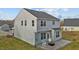 Exterior picture showcasing a backyard with a stone patio, rocking chairs, and fire pit at 106 Jared Ct, Graham, NC 27253
