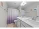 Bathroom with double sinks, tile floors, shower curtain, and neutral walls at 106 Jared Ct, Graham, NC 27253