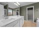 Bathroom featuring double sinks with a view of a walk-in closet and stand-up shower at 106 Jared Ct, Graham, NC 27253