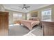 Bright bedroom features a tray ceiling, fan, neutral walls, carpet floors, and a large window at 106 Jared Ct, Graham, NC 27253
