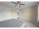 Bedroom featuring gray blanket, neutral walls, carpet floors, fan, and closet at 106 Jared Ct, Graham, NC 27253
