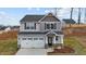Charming two-story home featuring gray siding, a two-car garage, and a well-manicured front yard at 106 Jared Ct, Graham, NC 27253