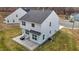 Aerial view of a two-story home showcasing backyard patio with fire pit at 106 Jared Ct, Graham, NC 27253