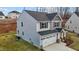 Corner view of a two-story home, two-car garage, and a manicured lawn at 106 Jared Ct, Graham, NC 27253