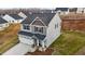 Aerial view of a two-story home with an attached two-car garage and manicured lawn at 106 Jared Ct, Graham, NC 27253