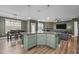 Spacious kitchen island with granite countertops and a view of the living area with stone fireplace at 106 Jared Ct, Graham, NC 27253