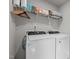 Functional laundry room with front load washer and dryer, and overhead storage at 106 Jared Ct, Graham, NC 27253