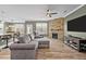 Comfortable living room with a stone fireplace, ceiling fan, and an adjacent dining area and kitchen at 106 Jared Ct, Graham, NC 27253