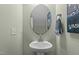 Contemporary powder room with a pedestal sink, decorative mirror, and stylish wall decor at 106 Jared Ct, Graham, NC 27253