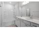 Bathroom featuring white cabinets, double vanity, mirror and bath tub with shower at 112 Central Townes Way # 294, Raleigh, NC 27603