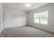 Bright bedroom features neutral carpeting and large windows offering views of the surrounding landscape at 112 Central Townes Way # 294, Raleigh, NC 27603