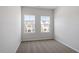 Bedroom features neutral carpeting and two large windows offering views of the neighborhood at 112 Central Townes Way # 294, Raleigh, NC 27603