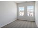 Bedroom features neutral carpeting and two large windows offering views of the neighborhood at 112 Central Townes Way # 294, Raleigh, NC 27603