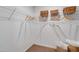 Walk-in closet with wire shelving and storage baskets at 112 Central Townes Way # 294, Raleigh, NC 27603