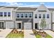 Charming townhome featuring a well-manicured lawn, a one car garage, and a welcoming entrance at 112 Central Townes Way # 294, Raleigh, NC 27603