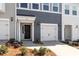 A townhome with a single-car garage, a neatly kept lawn, and a pleasant entryway at 112 Central Townes Way # 294, Raleigh, NC 27603