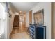 Inviting foyer with staircase, hardwood floors, stylish accents, and mirror at 112 Central Townes Way # 294, Raleigh, NC 27603