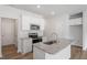 Eat-in kitchen with stainless appliances, granite counters, and white cabinetry at 112 Central Townes Way # 294, Raleigh, NC 27603