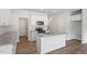 Modern kitchen with stainless steel appliances, granite countertops, and a central island at 112 Central Townes Way # 294, Raleigh, NC 27603