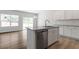 Kitchen with an island, stainless appliances, granite countertops, and wood-style floors at 112 Central Townes Way # 294, Raleigh, NC 27603
