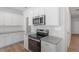 Modern kitchen boasts stainless steel appliances, granite countertops, white cabinets, and stylish subway tile backsplash at 112 Central Townes Way # 294, Raleigh, NC 27603